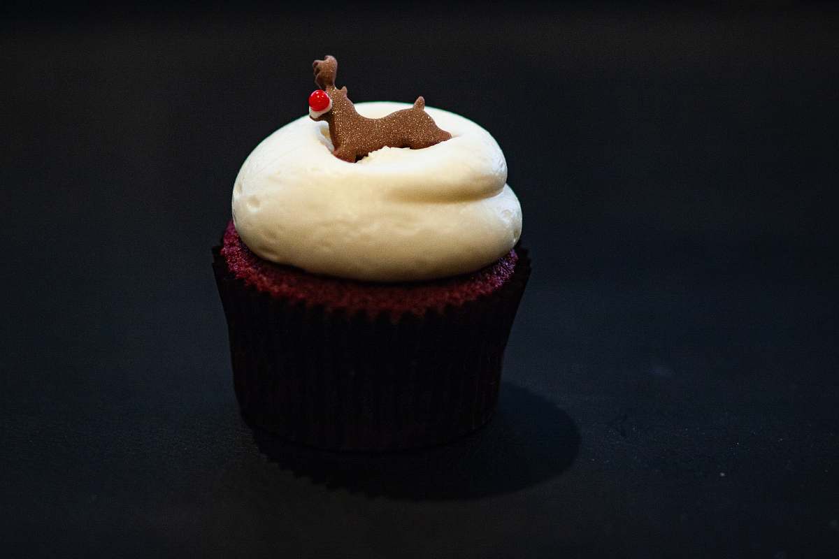 cream cupcake on black surface cupcake