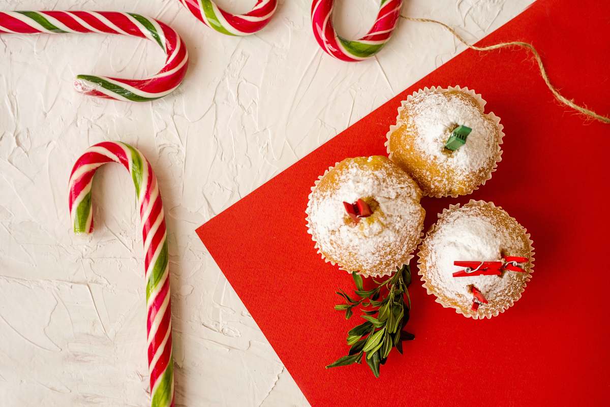 sweets cupcakes beside candy canes confectionery