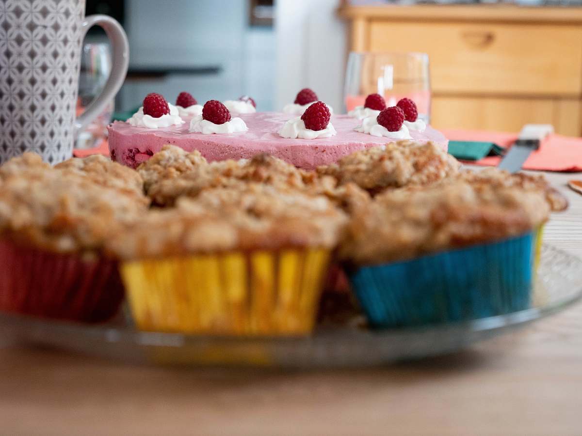 cake cupcakes near one layer cake with strawberries on top cream
