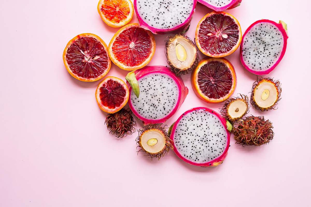 fruit flatlay photography of citrus and dragon pink