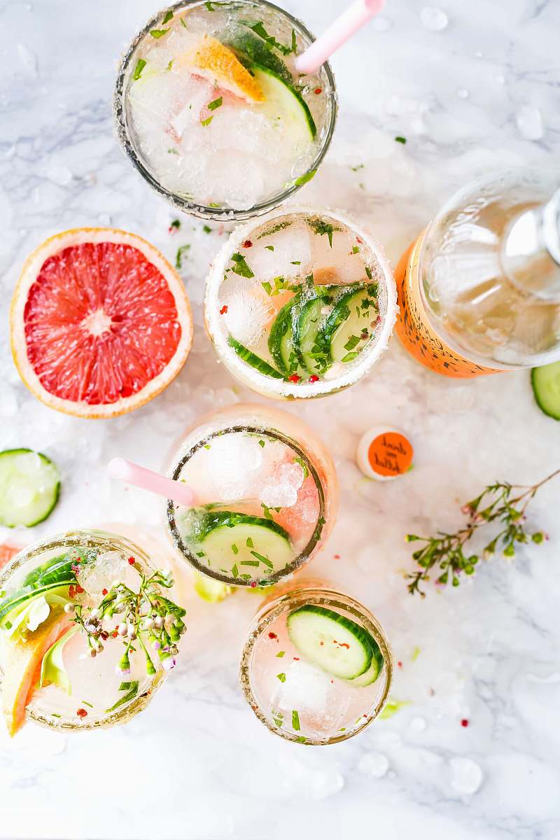 drink flatlay photography of sliced fruits and cucumbers cocktail