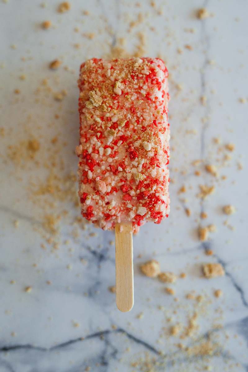 dessert focus photography of drumstick ice cream with toppings candy