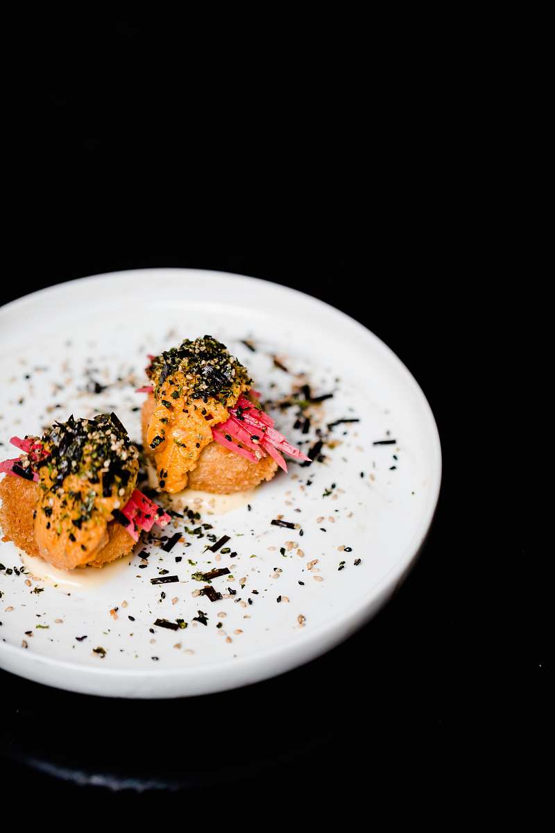 seasoning food on round white ceramic plate sesame