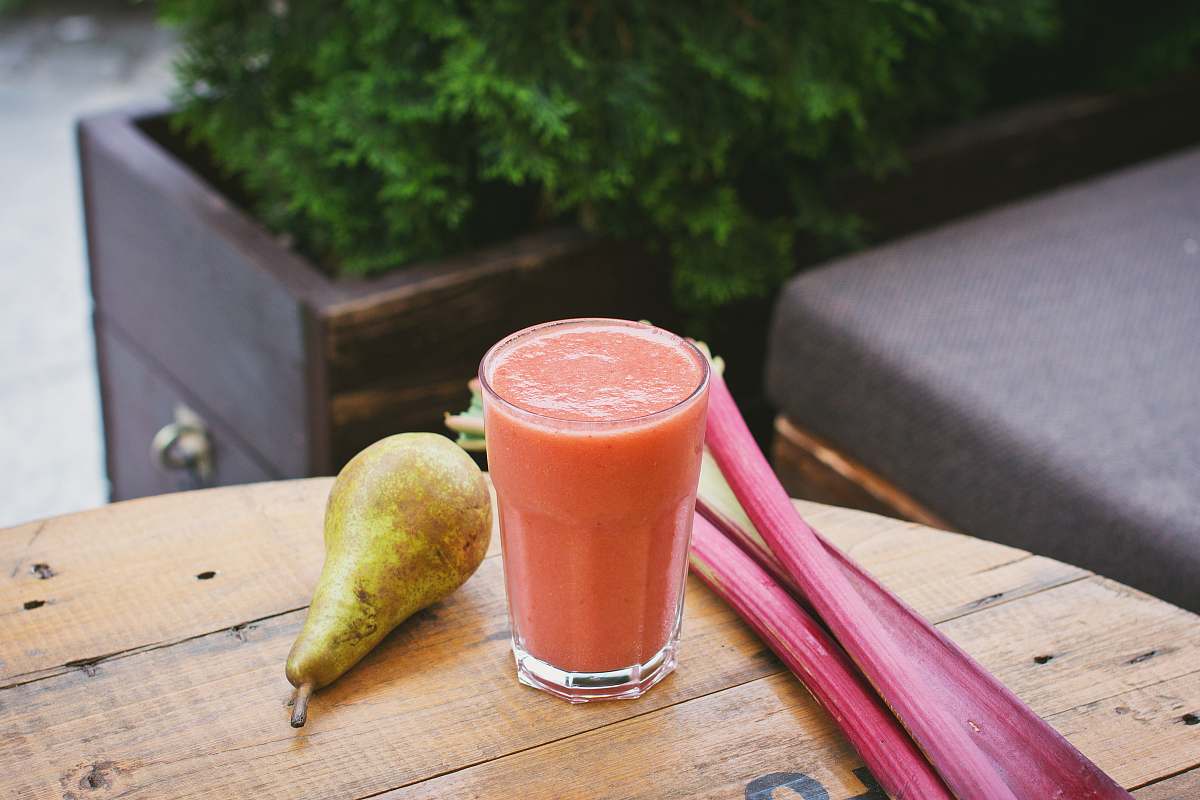 fruit glass cup near pear on table juice