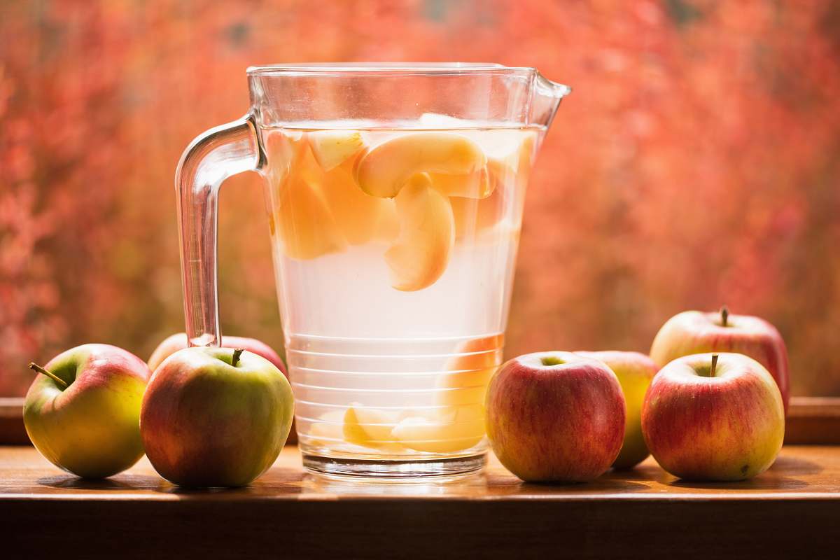 apple glass pitcher and apples on table produce