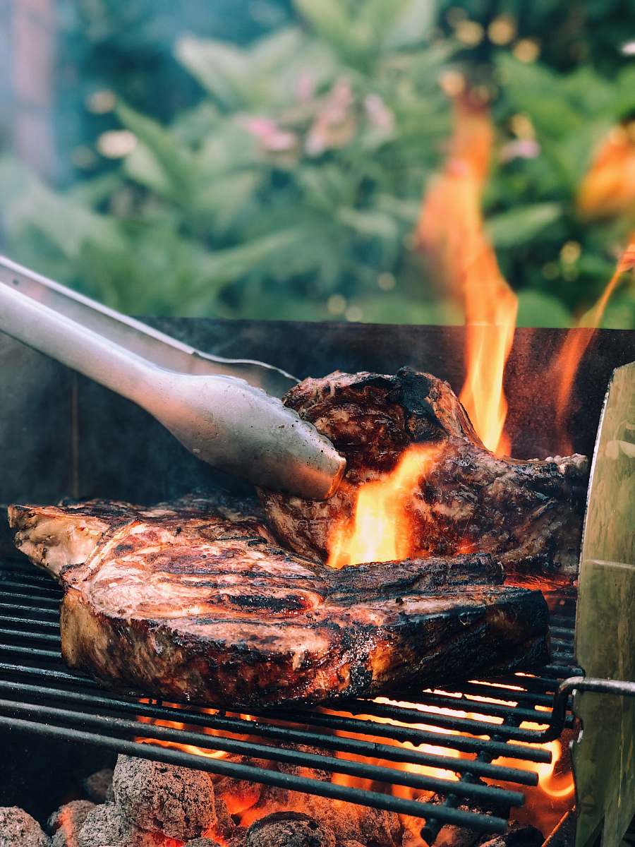 bbq gray metal tong and grilled meat with fire kablow