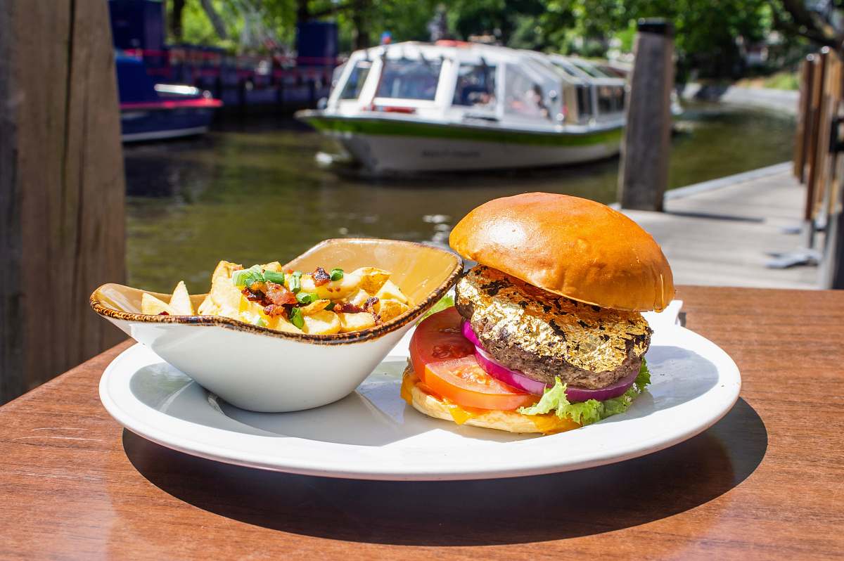 burger hamburger and salad on white tray boat