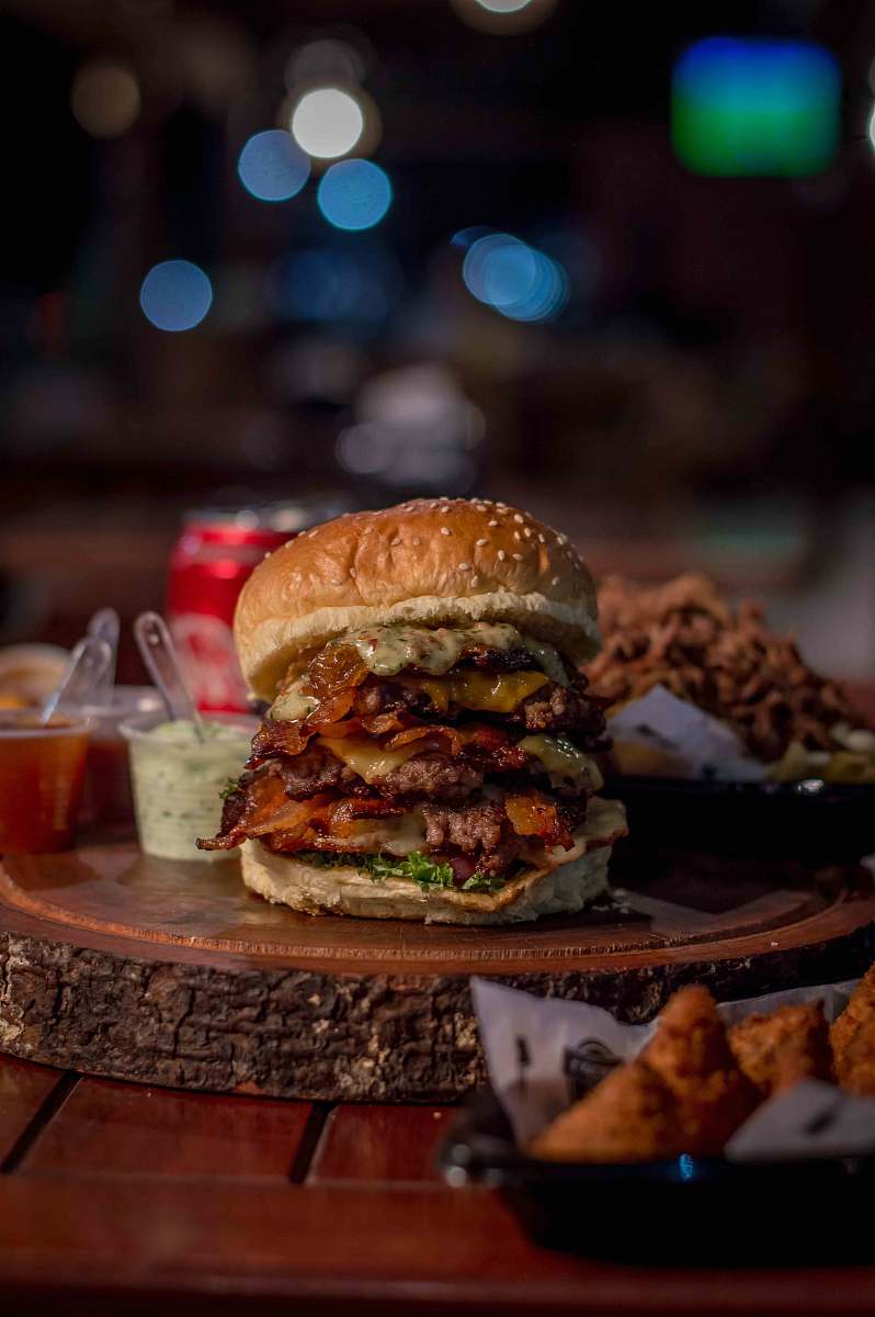 burger hamburger beside dips on slab brown