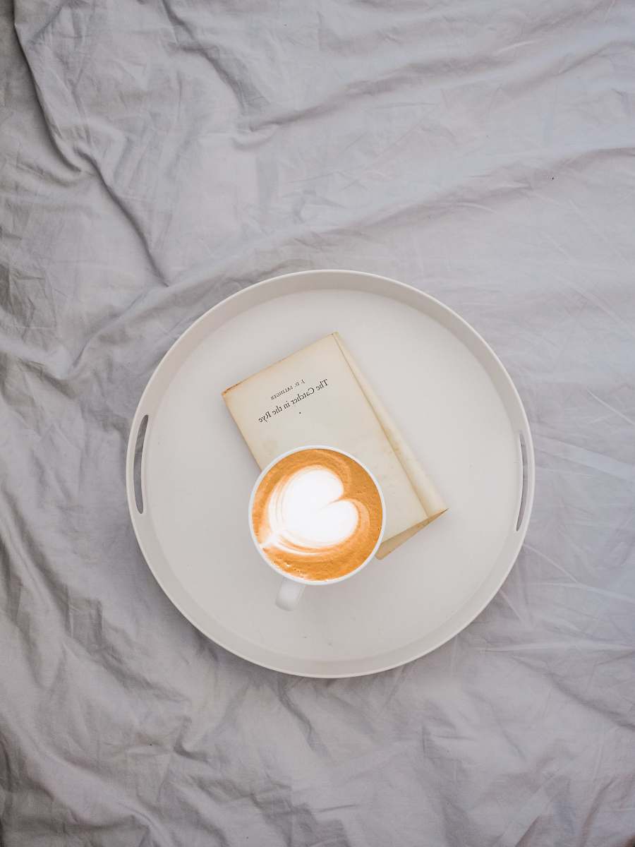 pottery latte art on round white tray saucer