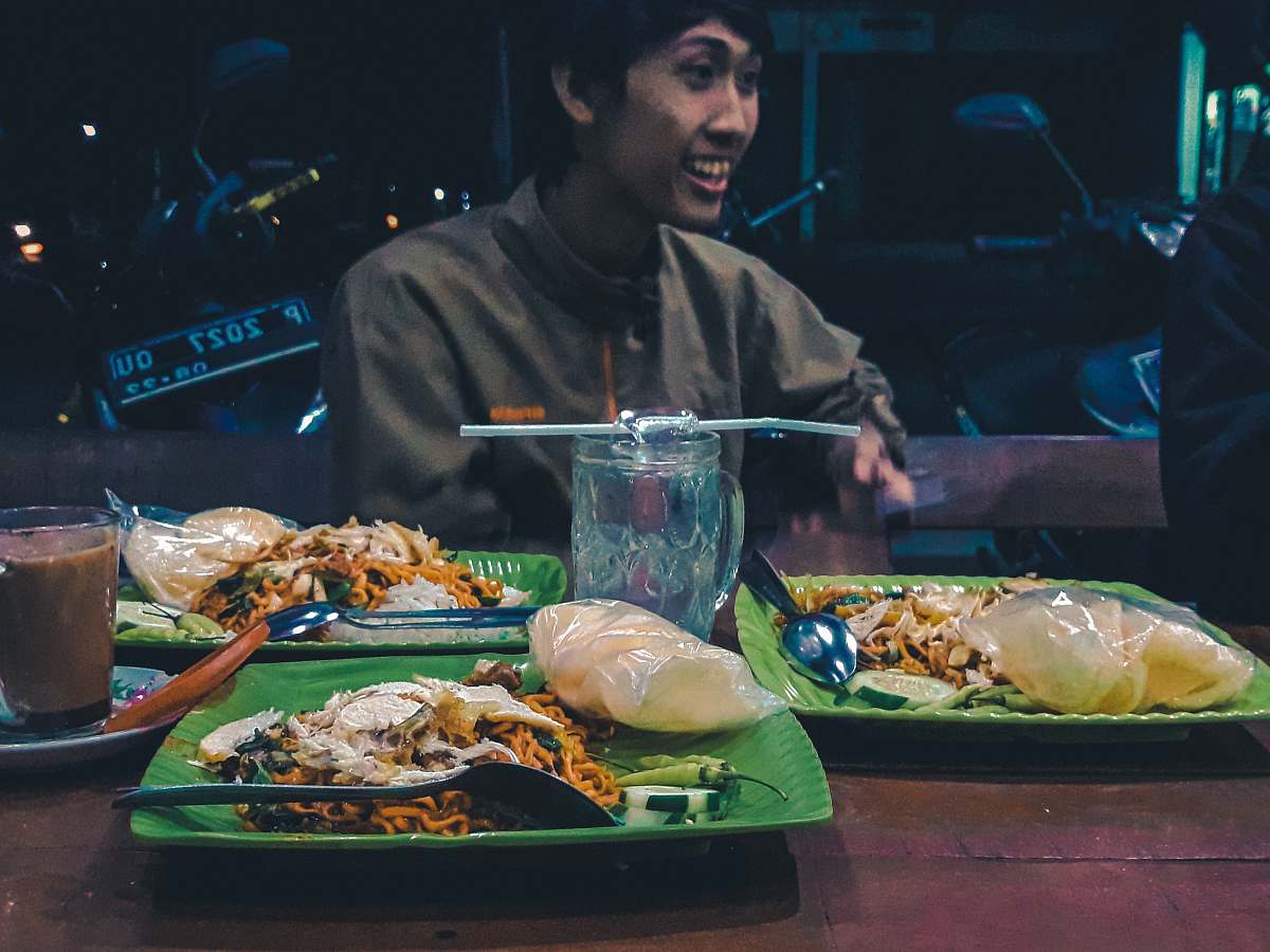 human man beside beside plate of food person