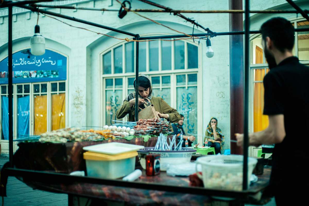 meal man in black polo shirt standing beside stand restaurant