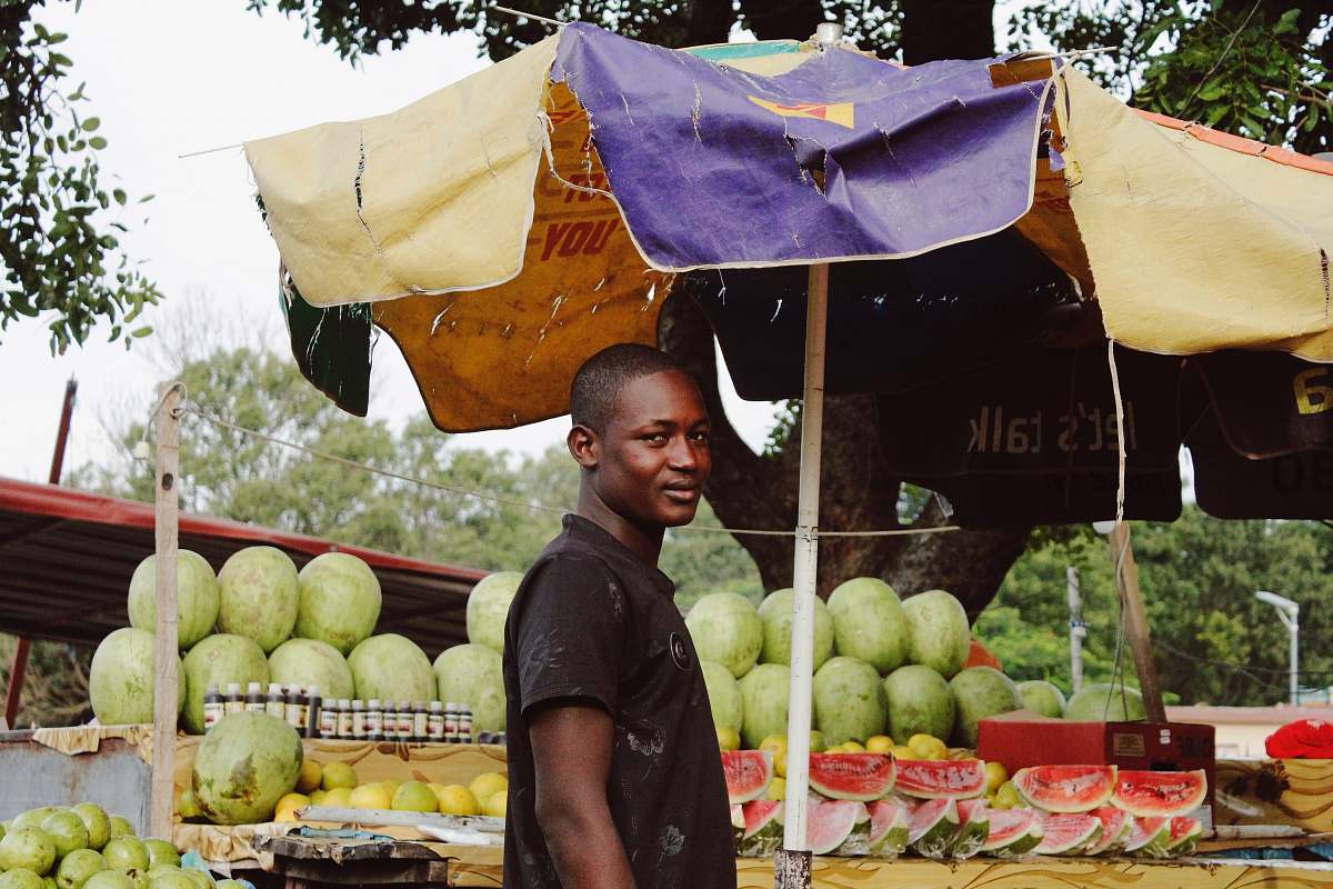 fruit man standing near watermelon fruit stand melon