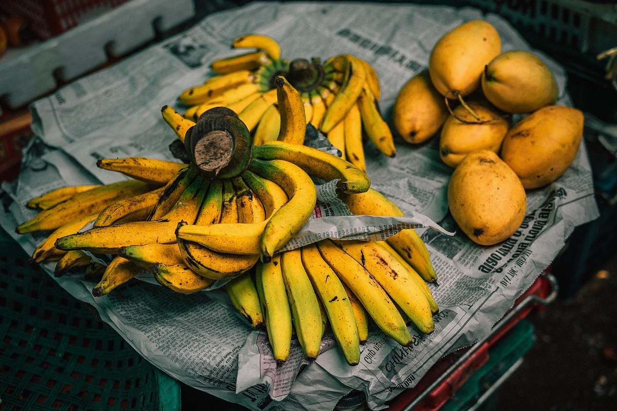 fruit mangoes and bananas on newspaper banana