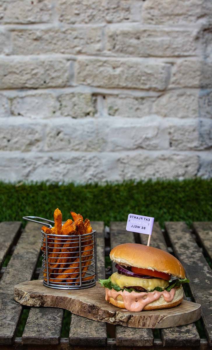 burger meat burger near basket of French fries bread