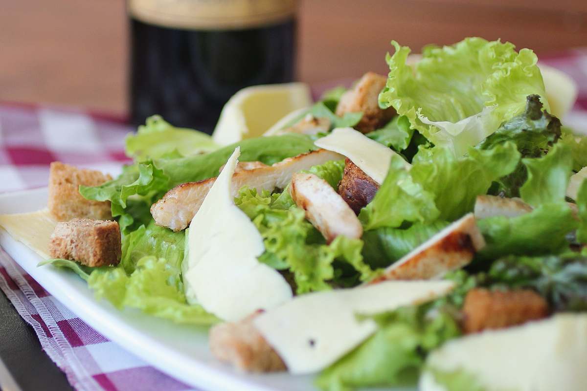 salad meat with lettuce on white ceramic plate produce