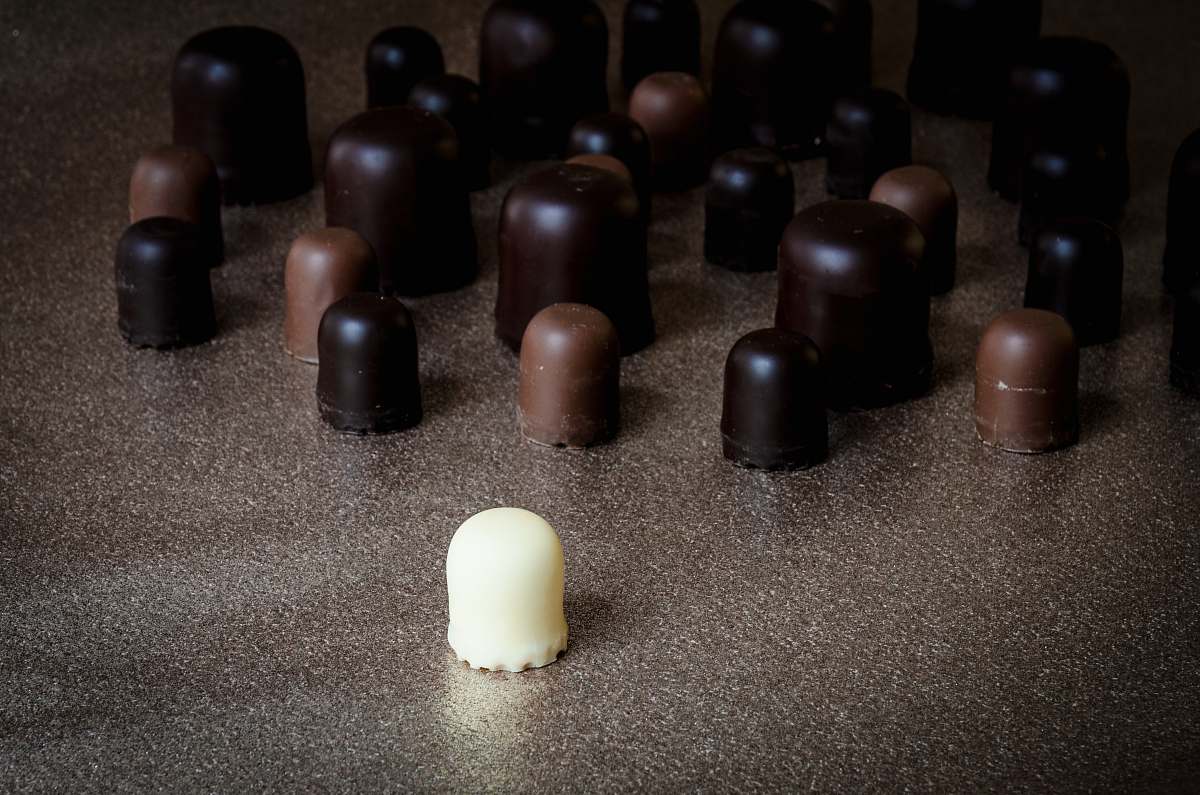 confectionery milk chocolate in front of scattered chocolates sweets