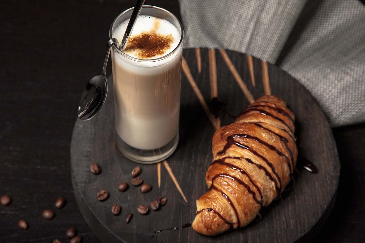 coffee milk in drinking glass neat break croissant