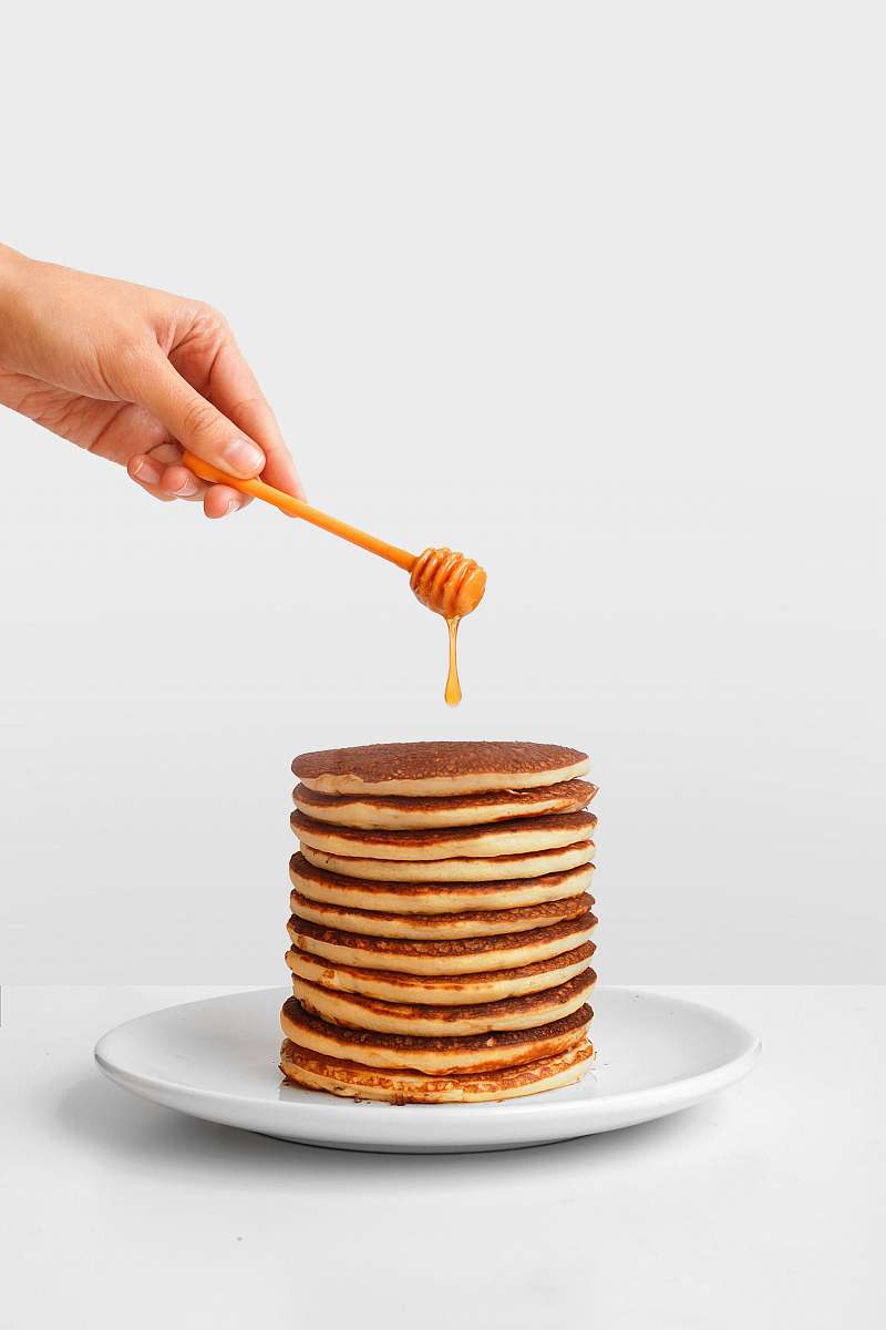 bread pancake with honey and honey dipper human