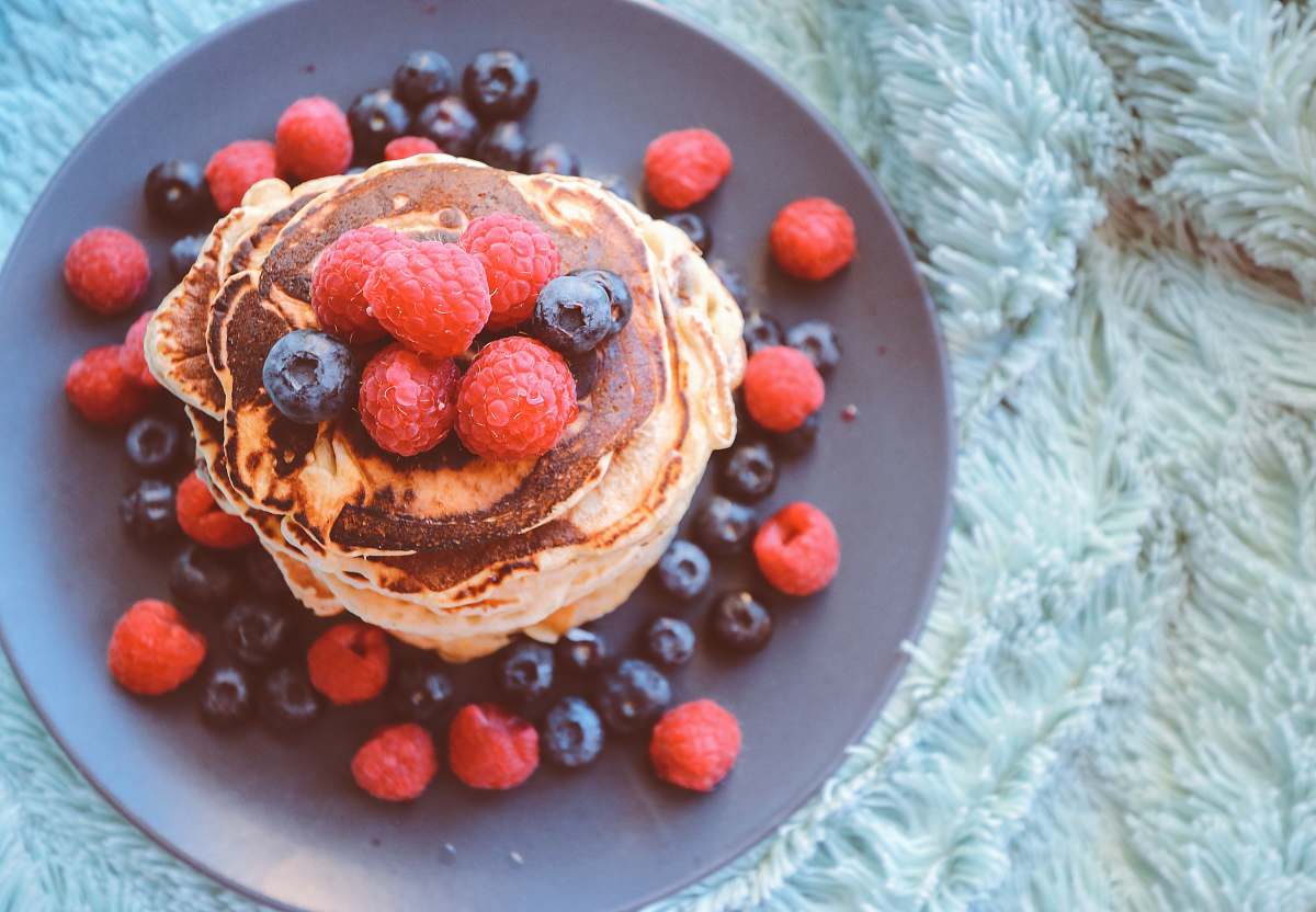 pancake pancakes with blueberries and raspberries on gray plate stack