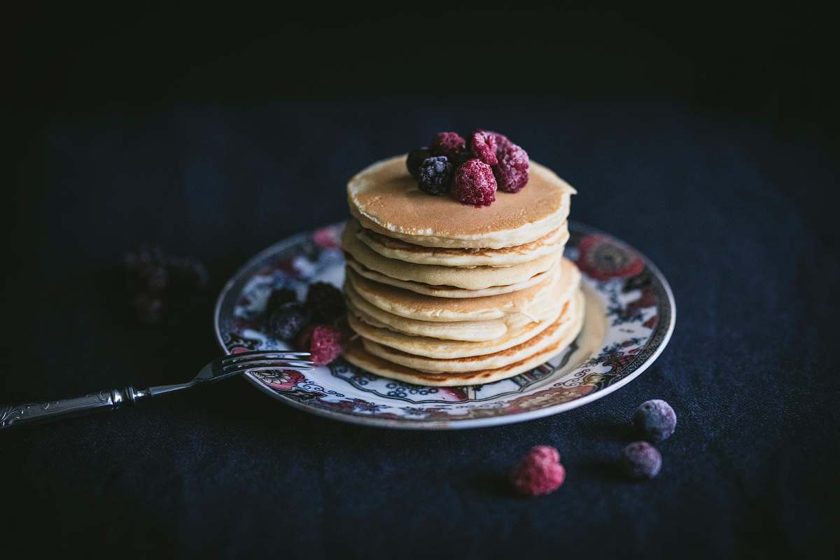 bread pancakes with raspberry toppings on saucer pancake