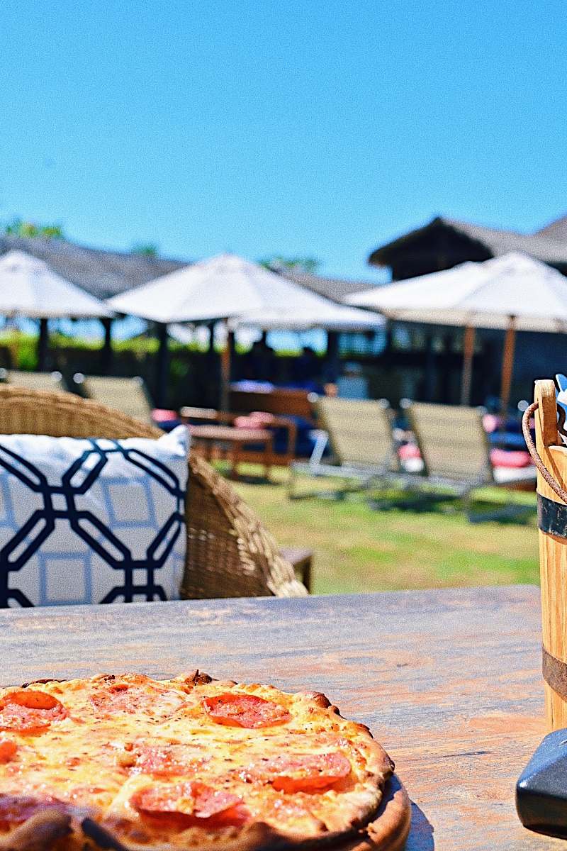 pizza pepperoni pizza on top of outside table during clear blue sky human