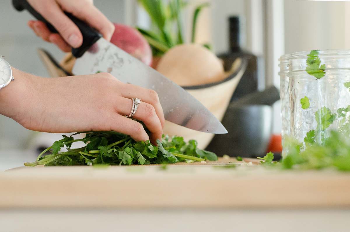 cooking person cutting vegetables with knife kitchen