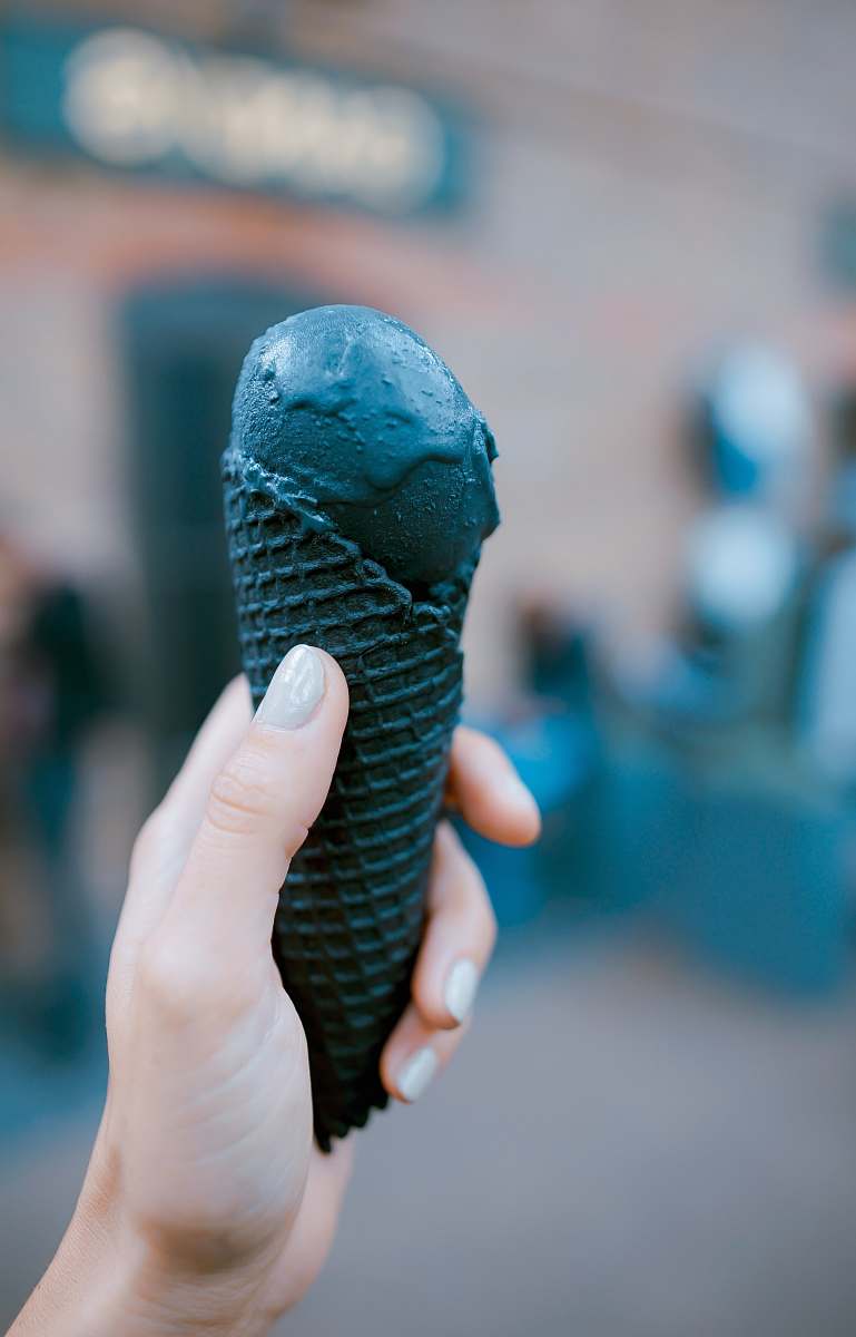 dessert person holding black ice cream ice cream