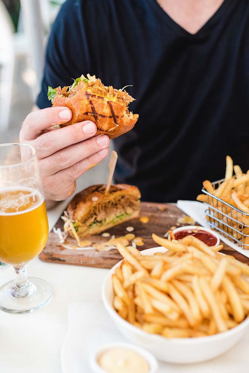 fries person holding bread in fruit of fried fries on white table human