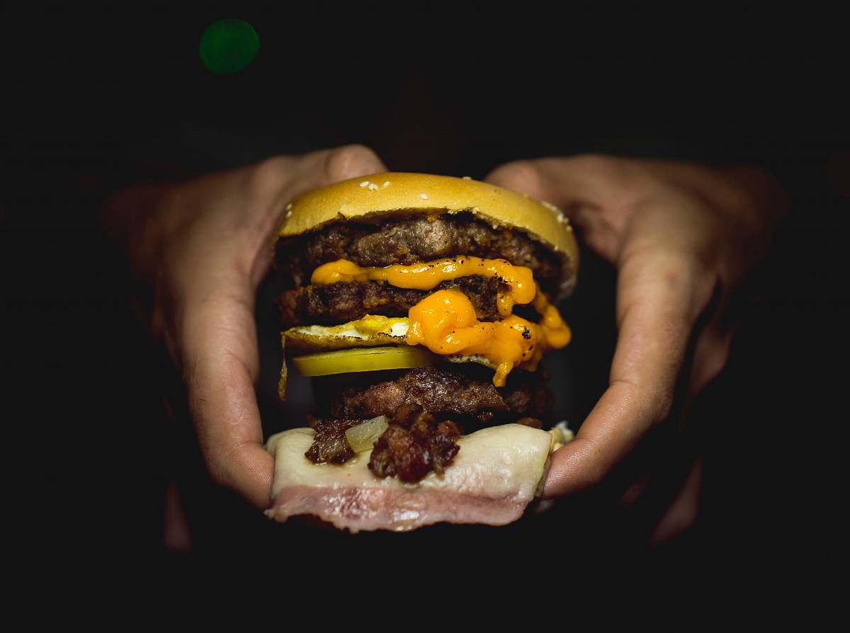 burger person holding hamburger dinner
