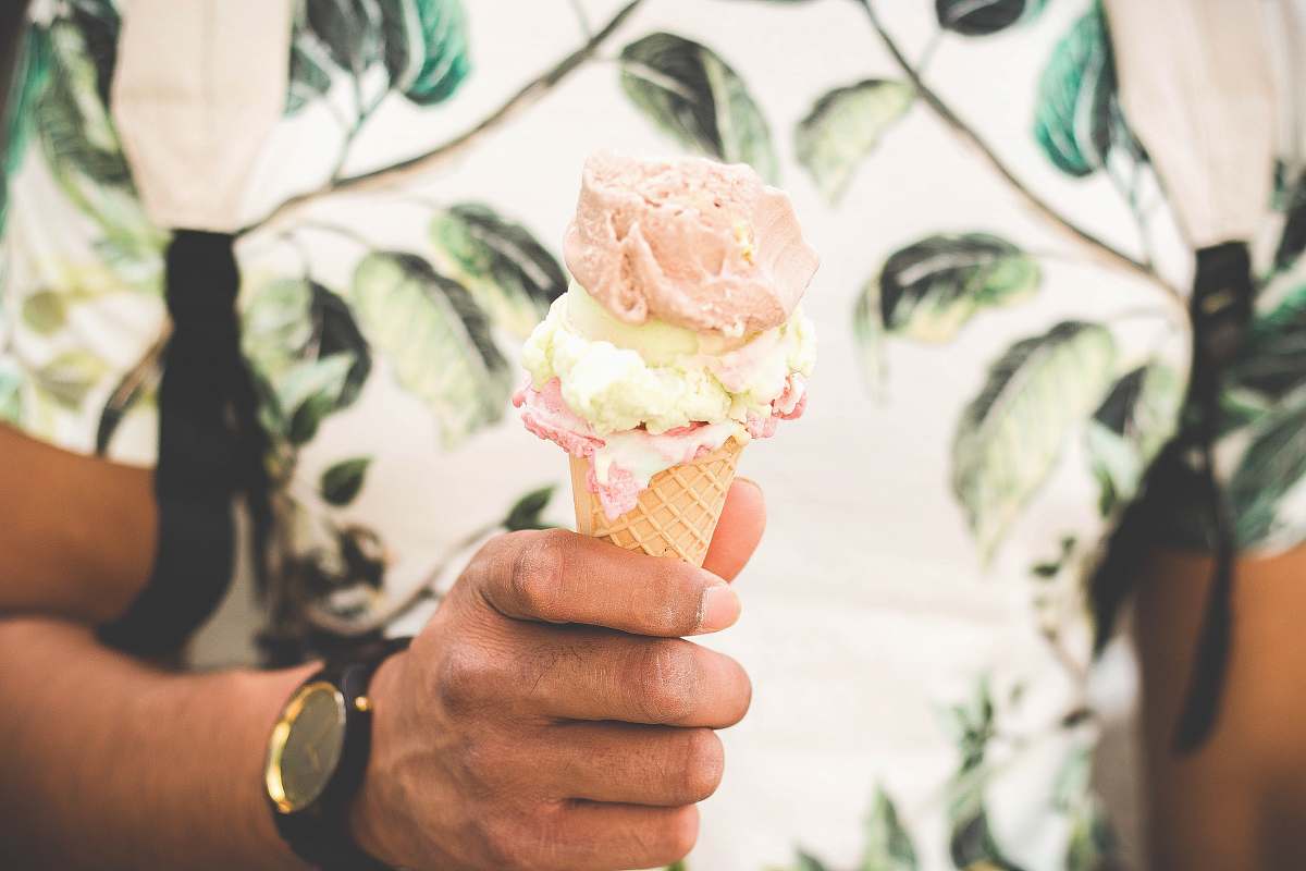 dessert person holding ice cream cone with three flavors of ice cream potted plant