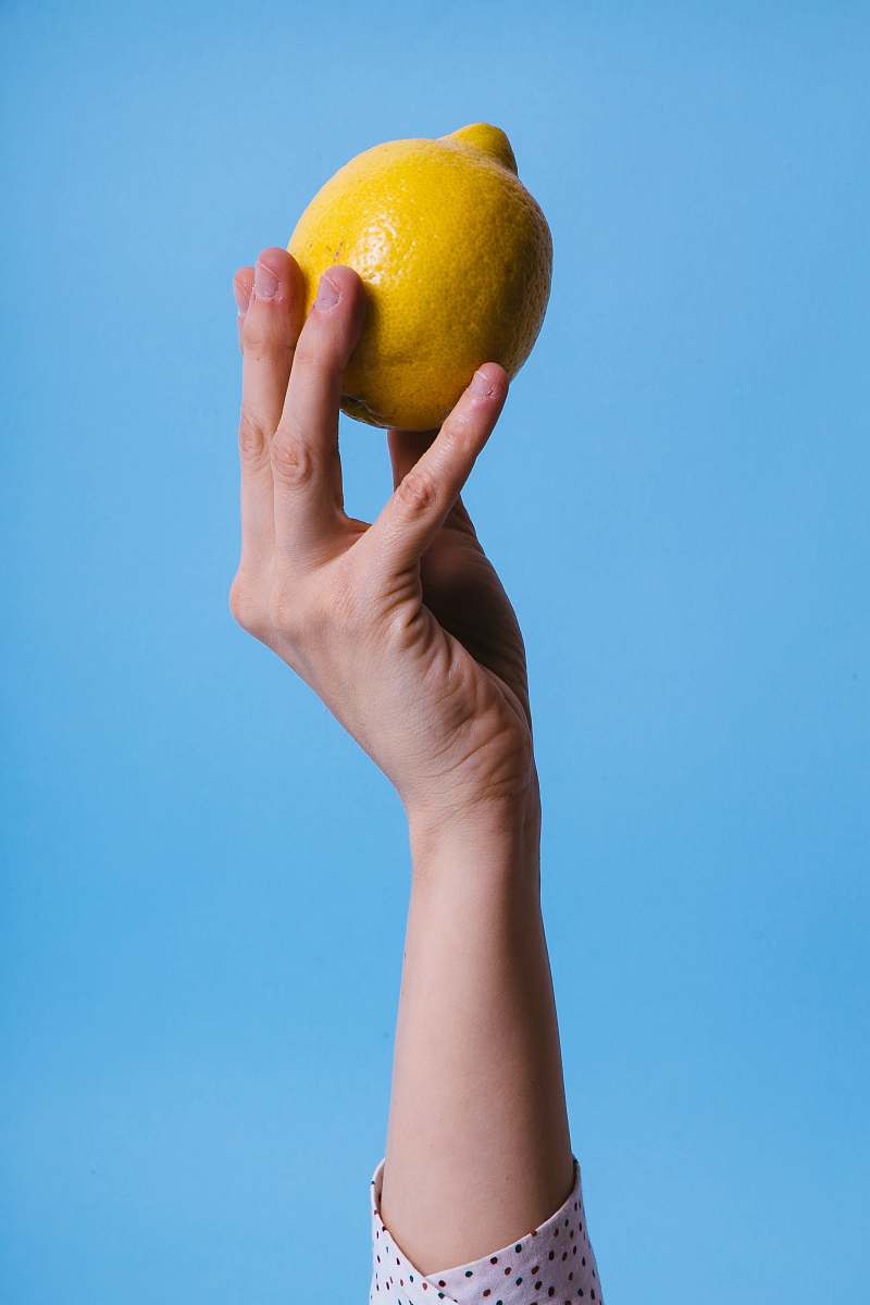 fruit person holding lemon grapefruit