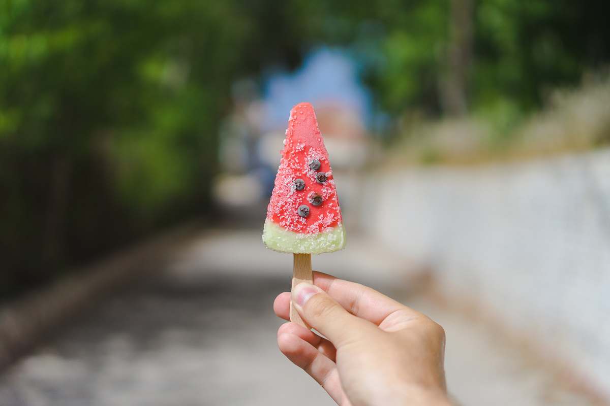 hand person holding popsicle during daytime hold