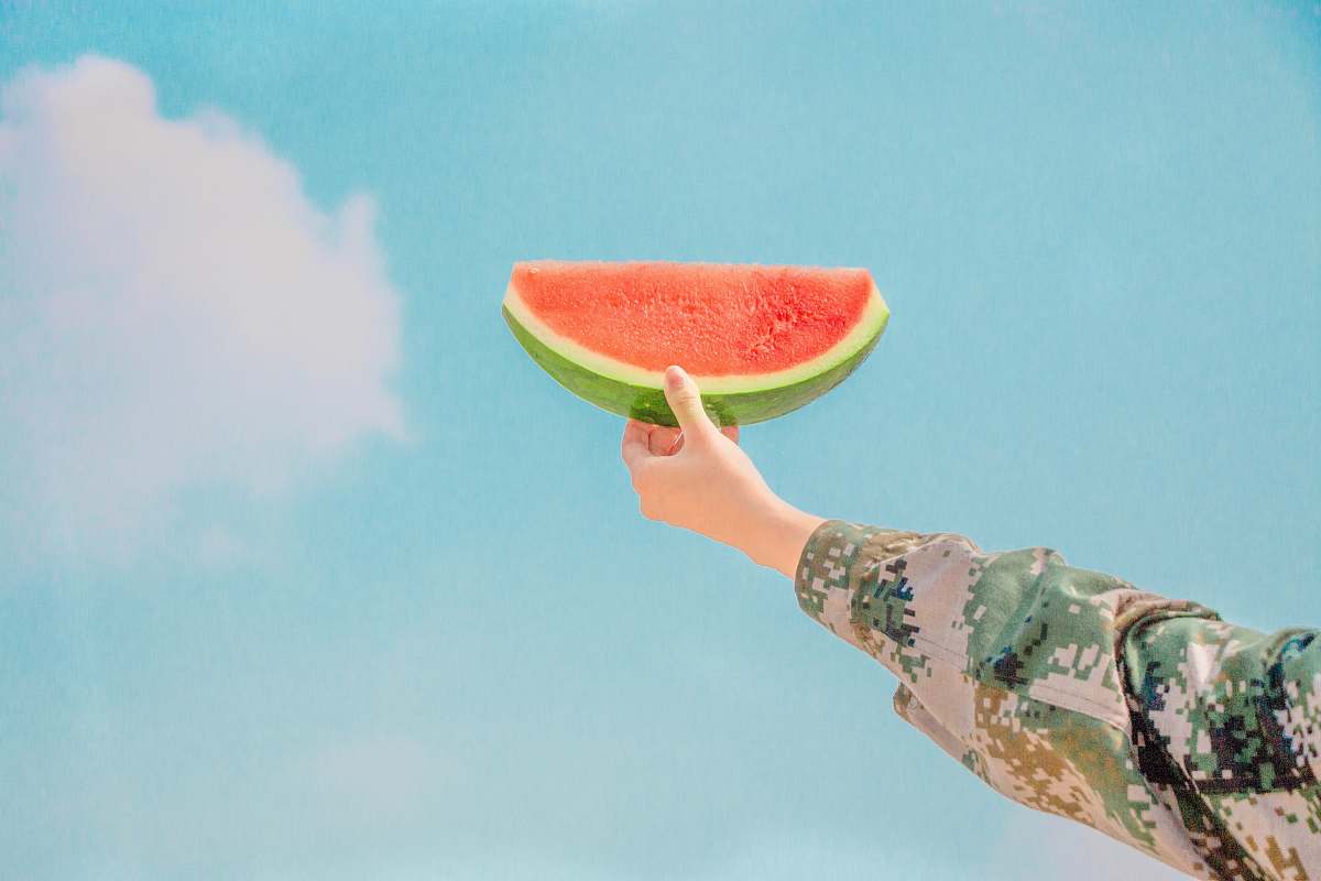 fruit person holding sliced watermelon watermelon