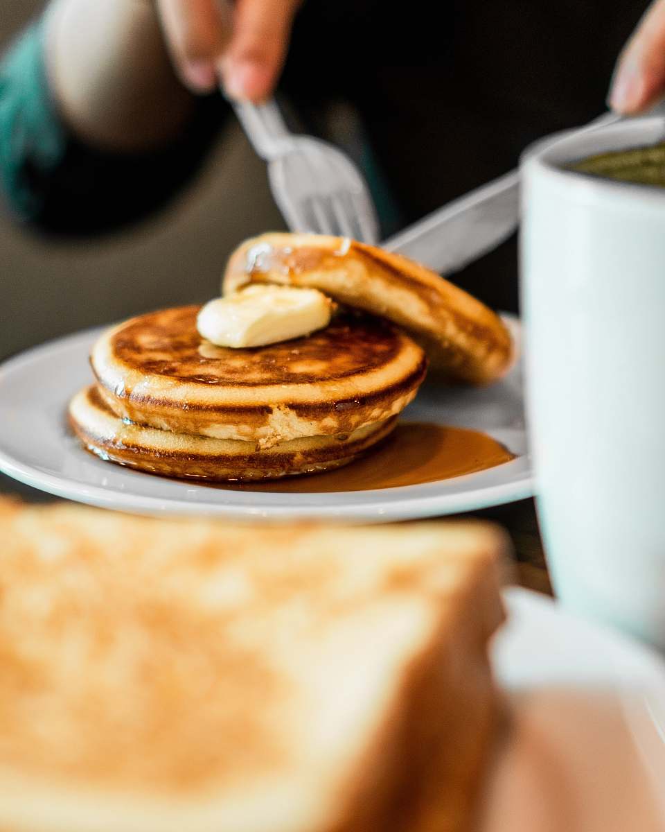 bread person slicing cake at table pancake