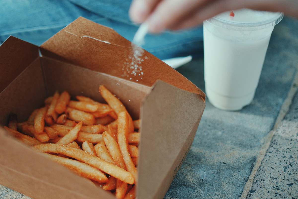 fries person sprinkling salt in fries watsons bay