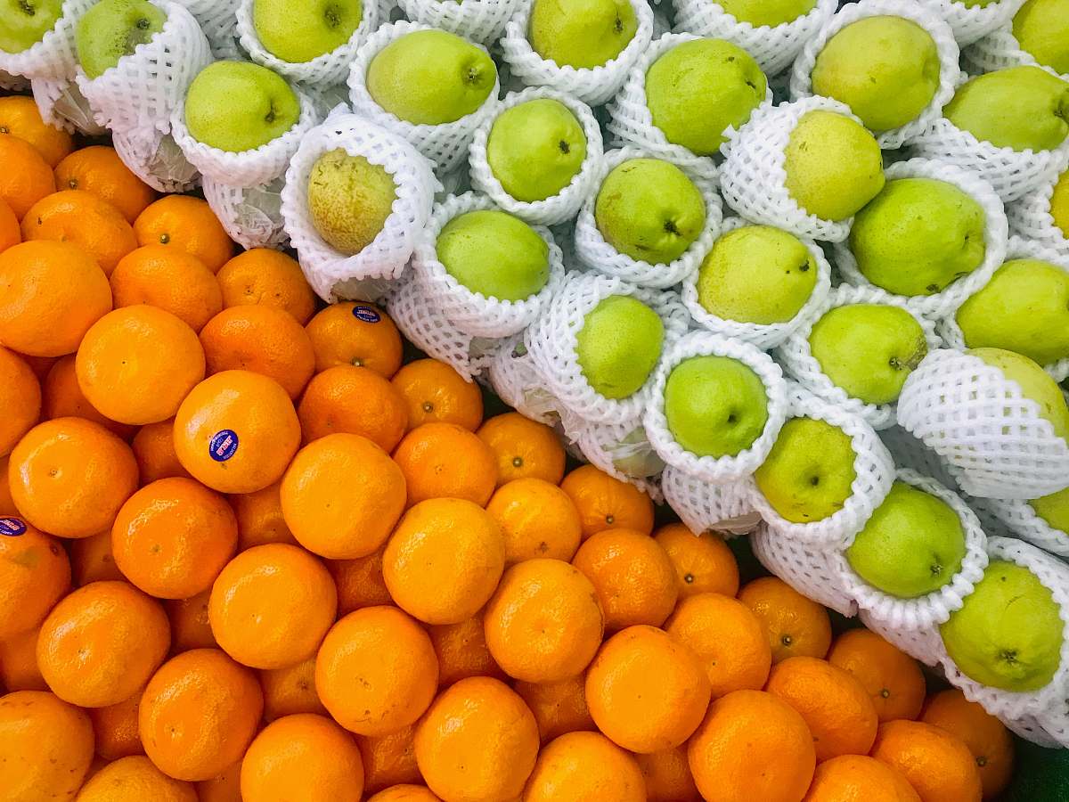 plant pile of green apples and orange fruits fruit