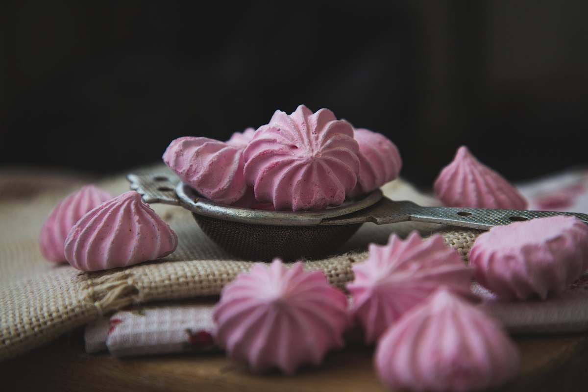 confectionery pink meringues on white textile sweets