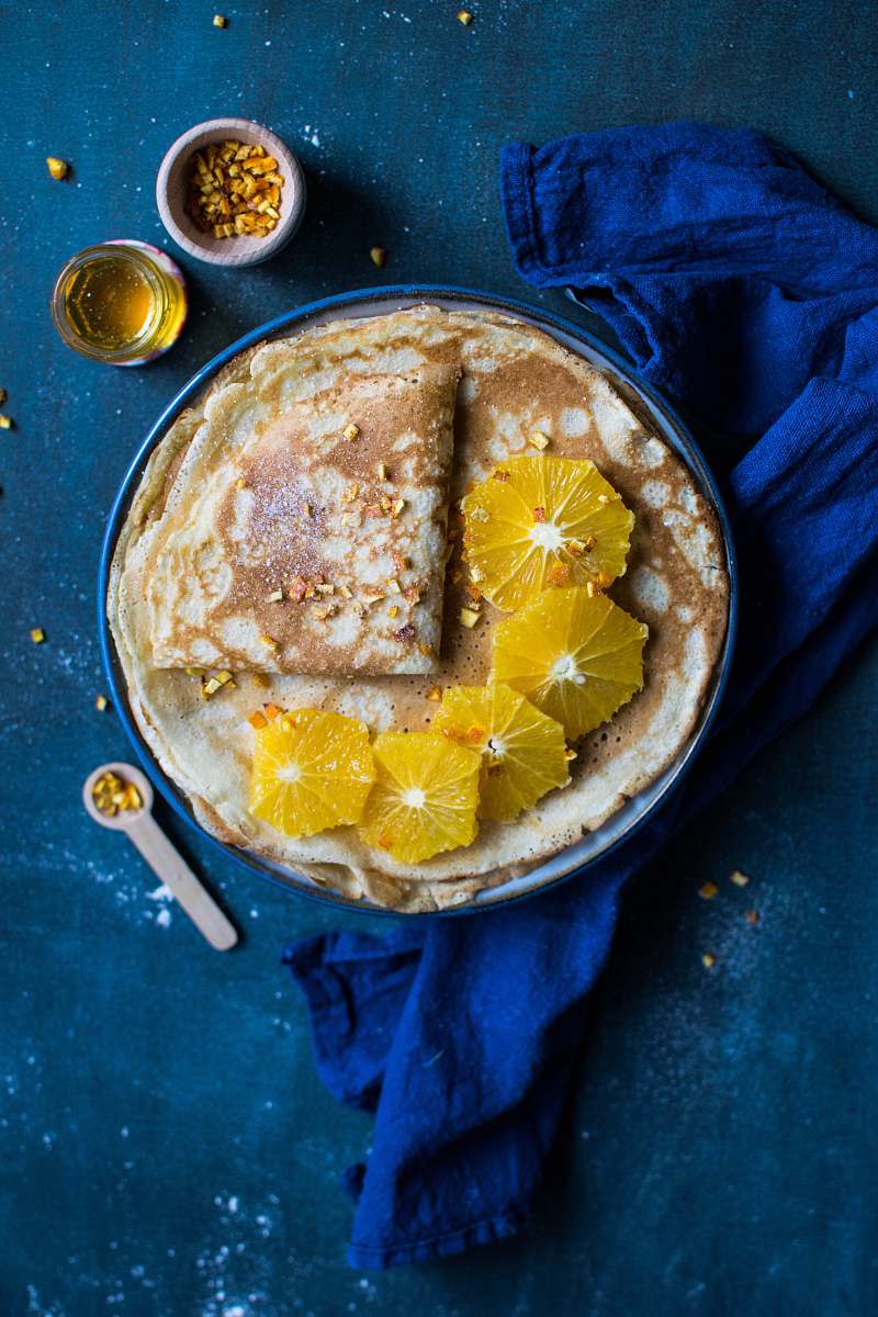 cornbread pita bread on blue plate beside white plastic spoon bread