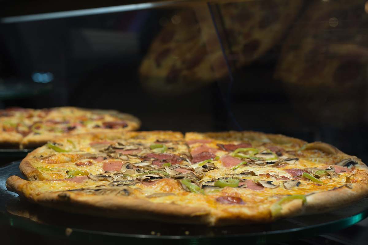 brown pizza being cooked pizza