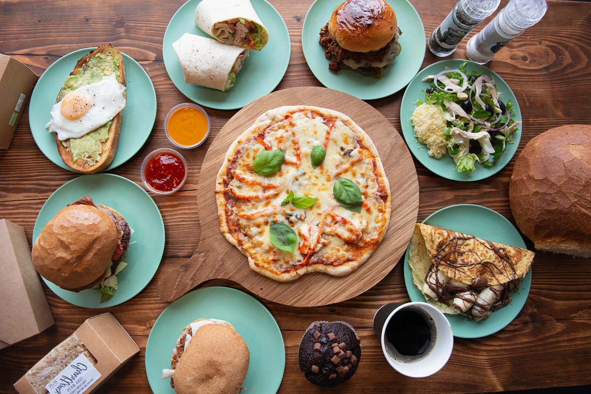 bread pizza between blue plates with taco, burger, and sandwich pizza