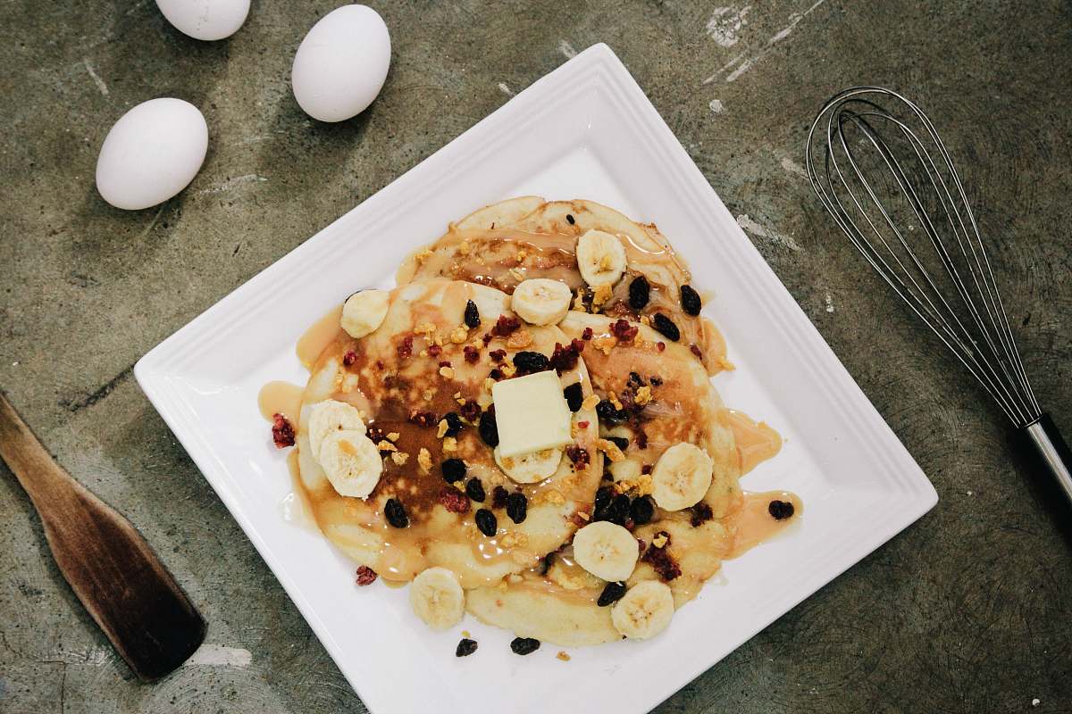plate plate of pancake topped with sliced bananas and chocolate syrup pancake