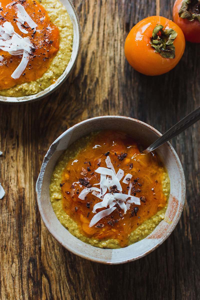 bowl porridge on bowl beside persimmon dish