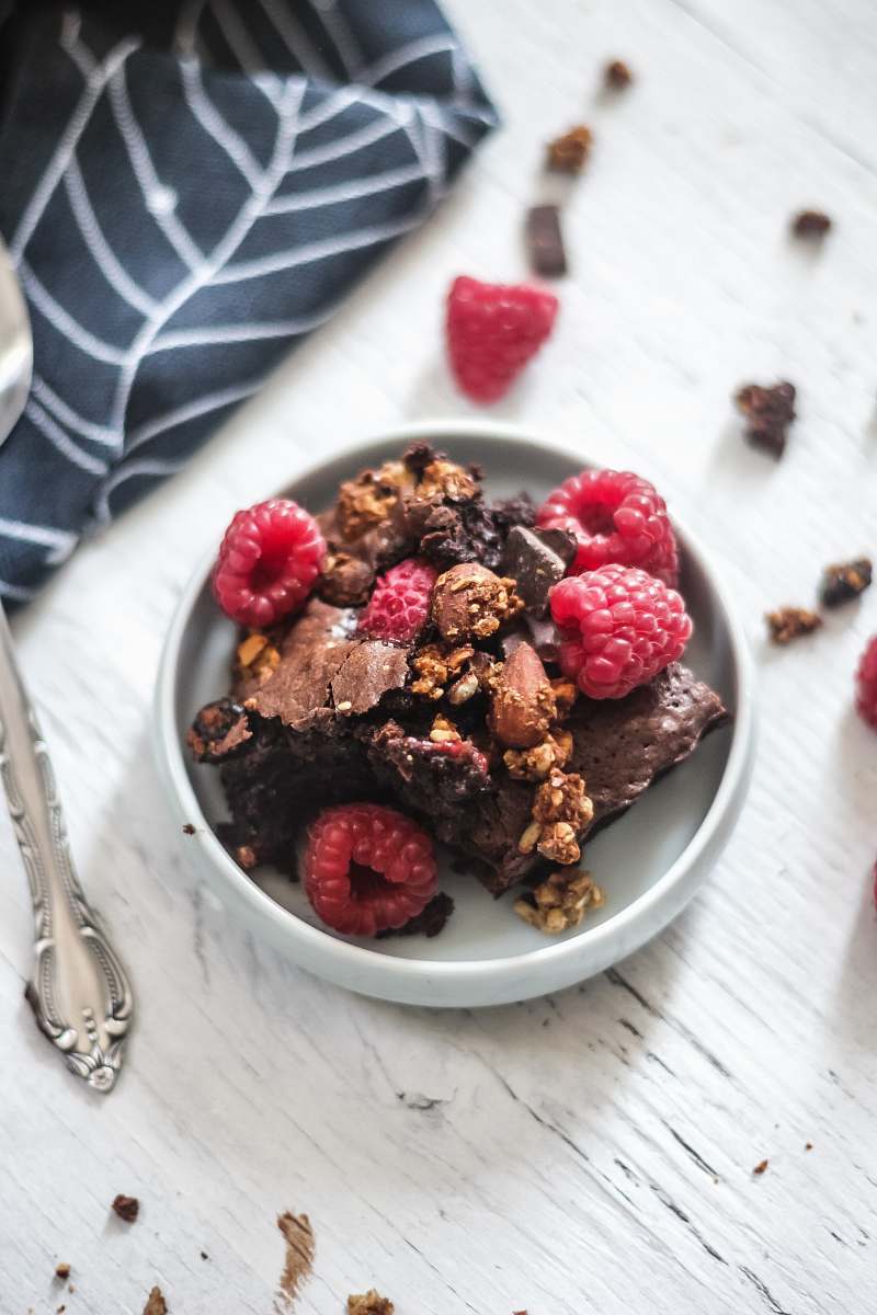 fruit raspberries and chocolate cake in plate on table plant
