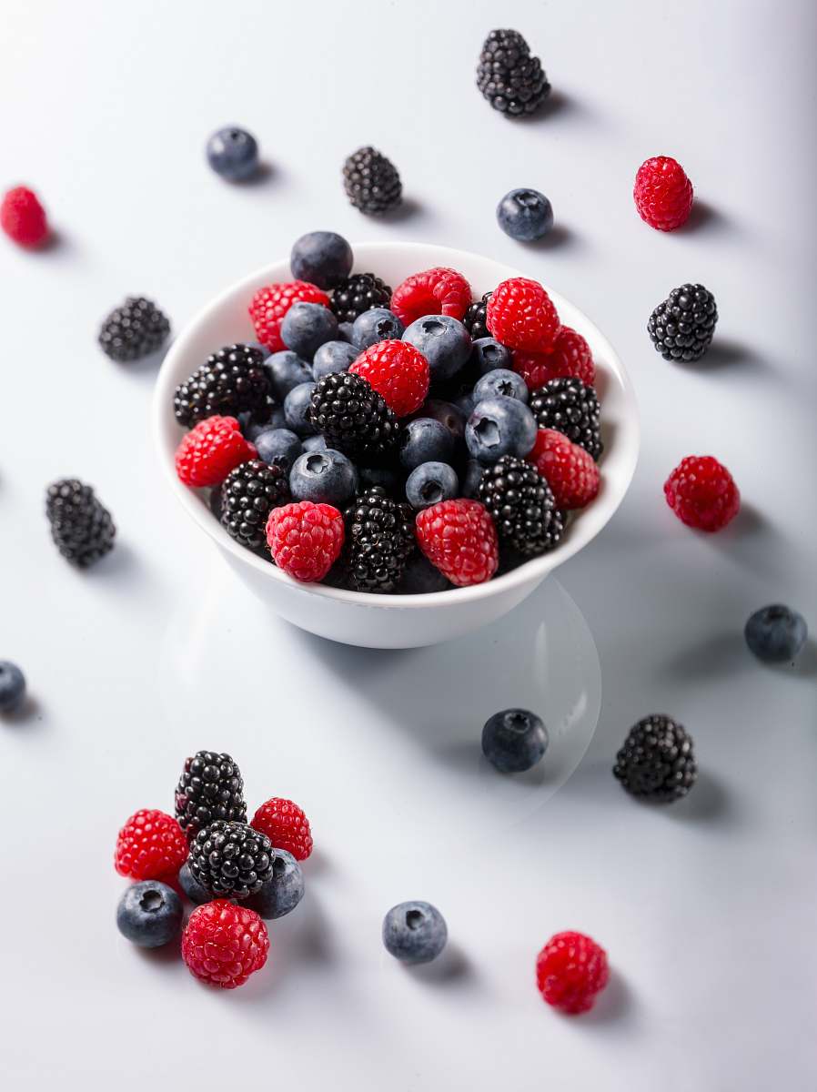 plant red and black raspberries on bowl blueberry