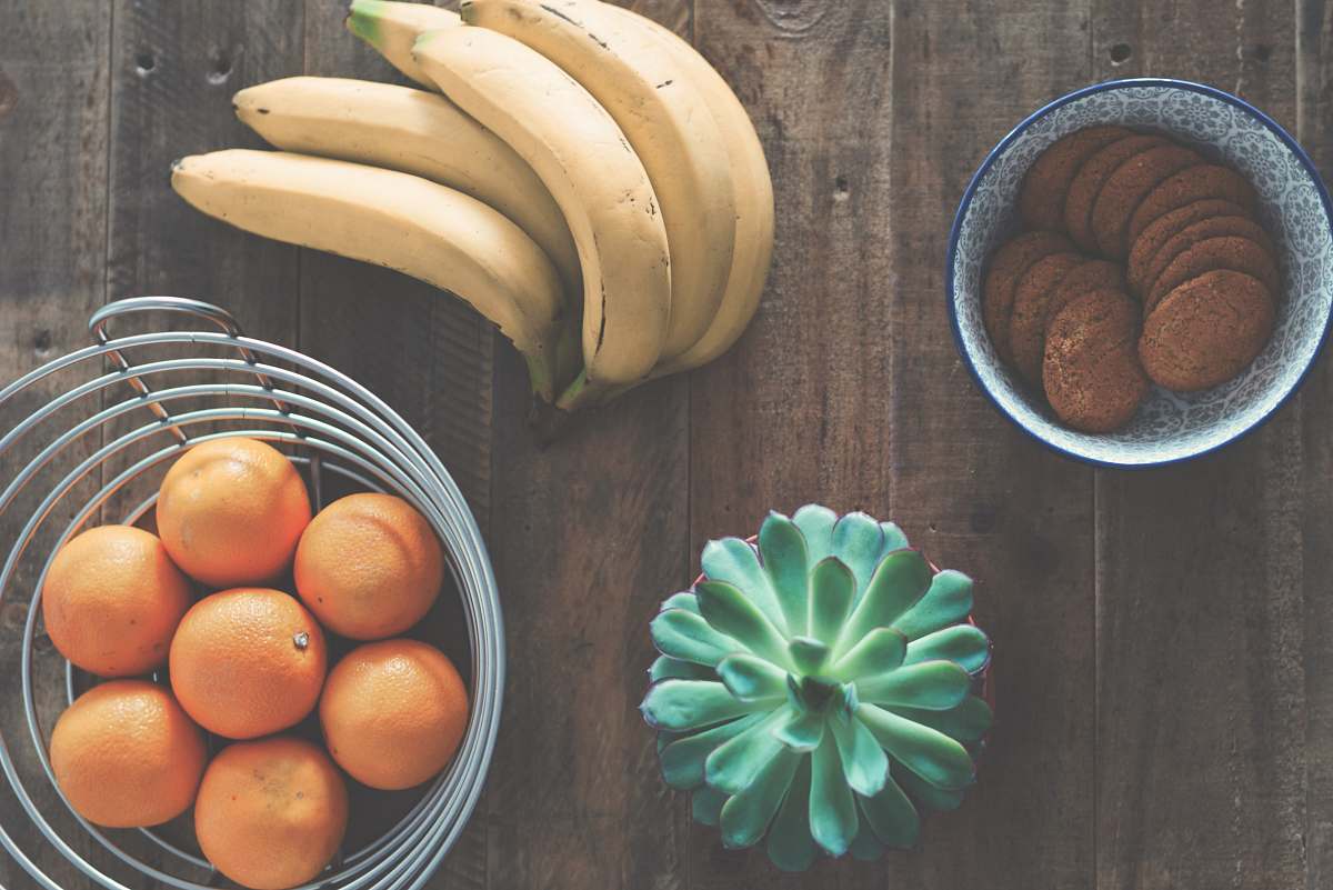 plant ripe banana fruit beside stainless steel fruit rack fruit