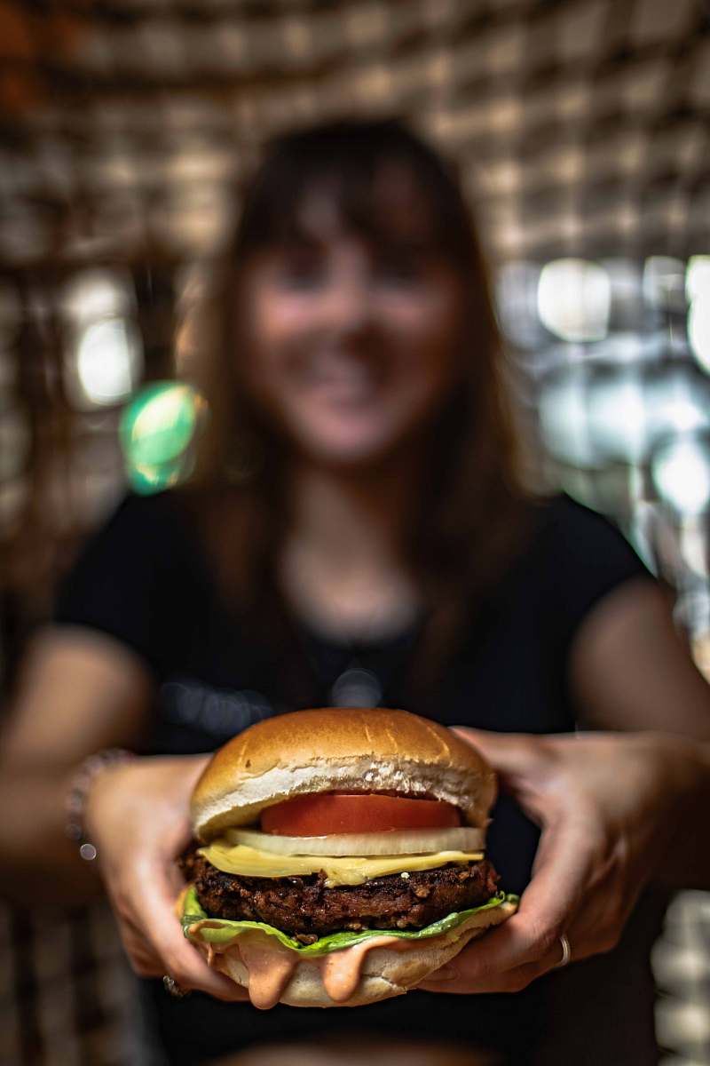 burger selective focus photography of burger human