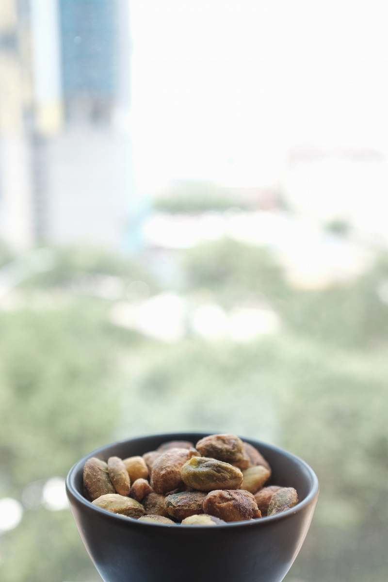 nuts selective focus photography of nuts on black ceramic bowl nut