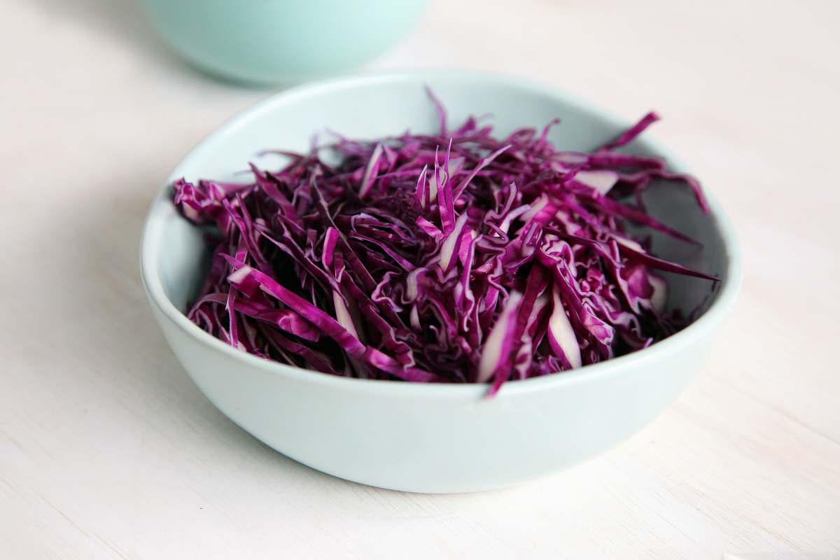 vegetable selective focus photography of purple petal filled bowl bowl