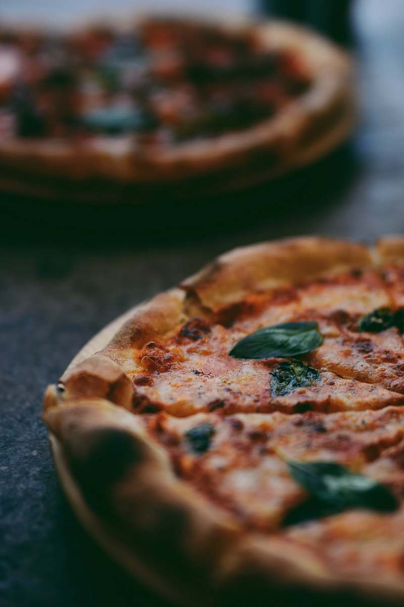 pizza selective focus photography of two pizzas shiraz