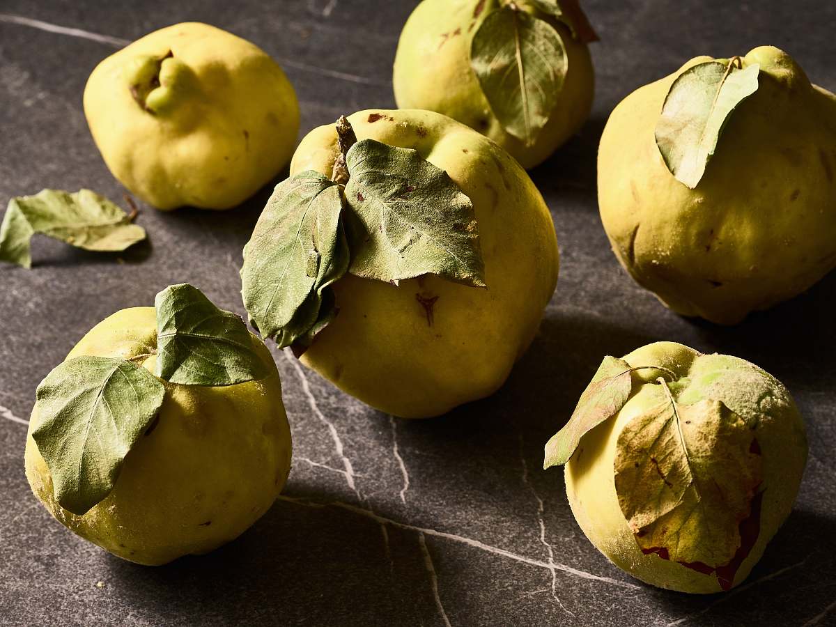 produce several round green citrus fruits quince